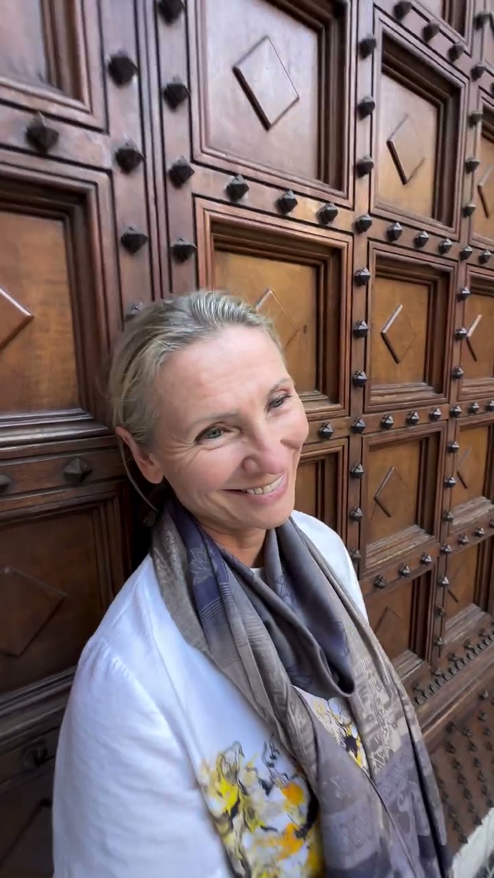 Elvira Wright in front of an old wooden door in Italy